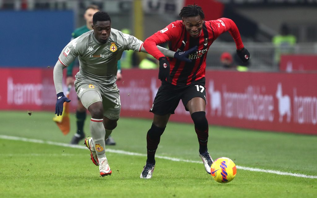 MILAN, ITALY - JANUARY 13: Caleb Ekuban of Genoa CFC and Rafael Leao of AC Milan battle for the ball during the Coppa Italia match between AC Milan and Genoa CFC at Stadio Giuseppe Meazza on January 13, 2022 in Milan, Italy. (Photo by Marco Luzzani/Getty Images)
