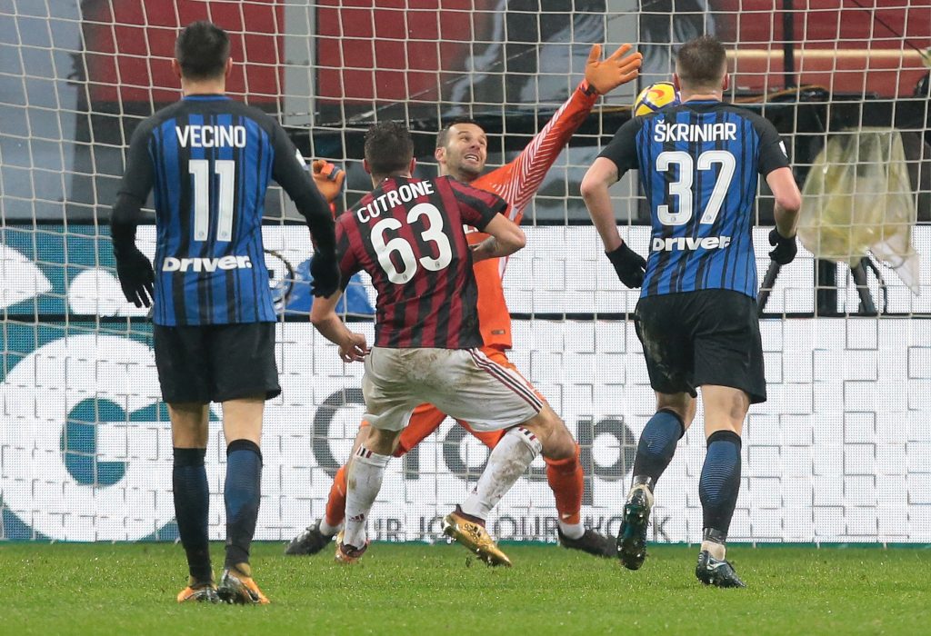 MILAN, ITALY - DECEMBER 27: Patrick Cutrone of AC Milan (C) scores the opening goal during the TIM Cup match between AC Milan and FC Internazionale at Stadio Giuseppe Meazza on December 27, 2017 in Milan, Italy. (Photo by Emilio Andreoli/Getty Images)