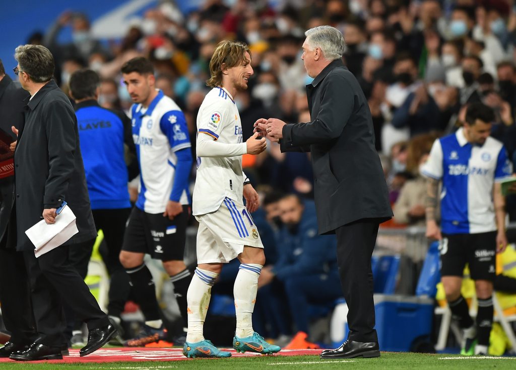 MADRID, SPAIN - FEBRUARY 19: Luka Modric of Real Madrid reacts with Carlo Ancelotti, head coach of Real Madrid after being substituted during the LaLiga Santander match between Real Madrid CF and Deportivo Alaves at Estadio Santiago Bernabeu on February 19, 2022 in Madrid, Spain. (Photo by Denis Doyle/Getty Images)
