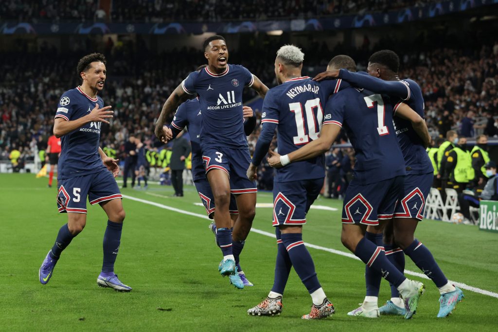 MADRID, SPAIN - MARCH 09: Kylian Mbappe (2ndR) of Paris Saint-Germain celebrates scoring their opening goal with teammate Neymar JR (3rdL), Marcos Aoas alias Marquinhos (L) and Presnel Kimpembe (2ndL) during the UEFA Champions League Round Of Sixteen Leg Two match between Real Madrid and Paris Saint-Germain at Estadio Santiago Bernabeu on March 09, 2022 in Madrid, Spain. (Photo by Gonzalo Arroyo Moreno/Getty Images)