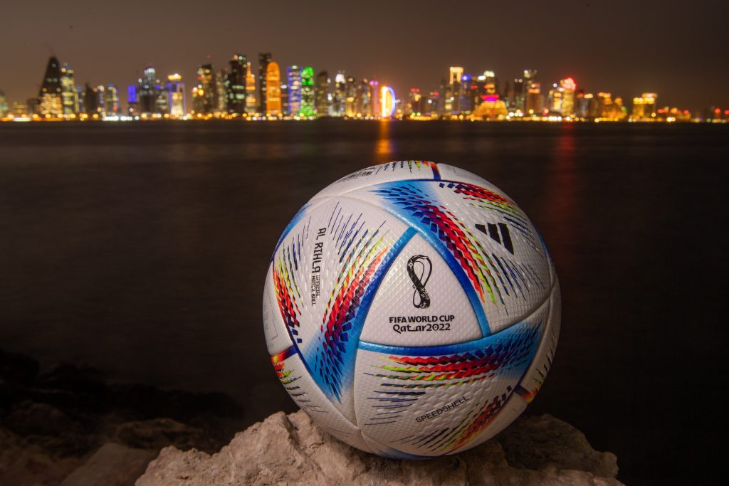 DOHA, QATAR - MARCH 31: In this photo illustration an official FIFA World Cup Qatar 2022 ball sits on display in front of the skyline of Doha ahead of the FIFA World Cup Qatar 2022 draw on March 31, 2022 in Doha, Qatar. (Photo by David Ramos/Getty Images)