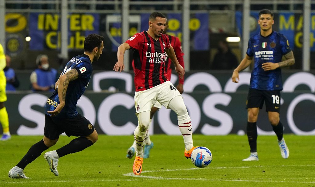 MILAN, ITALY - APRIL 19: Ismael Bennacer of AC Milan is challenged by Hakan Calhanoglu of FC Internazionale during the Coppa Italia Semi Final 2nd Leg match between FC Internazionale v AC Milan at Giuseppe Meazza Stadium on April 19, 2022 in Milan, Italy. (Photo by Pier Marco Tacca/AC Milan via Getty Images)