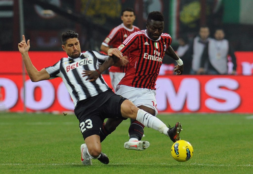 MILAN, ITALY - FEBRUARY 25: Sulley Ali Muntari (R) of AC Milan is challenged by Marco Borriello of Juventus FC during the Serie A match between AC Milan and Juventus FC at Stadio Giuseppe Meazza on February 25, 2012 in Milan, Italy. (Photo by Valerio Pennicino/Getty Images)