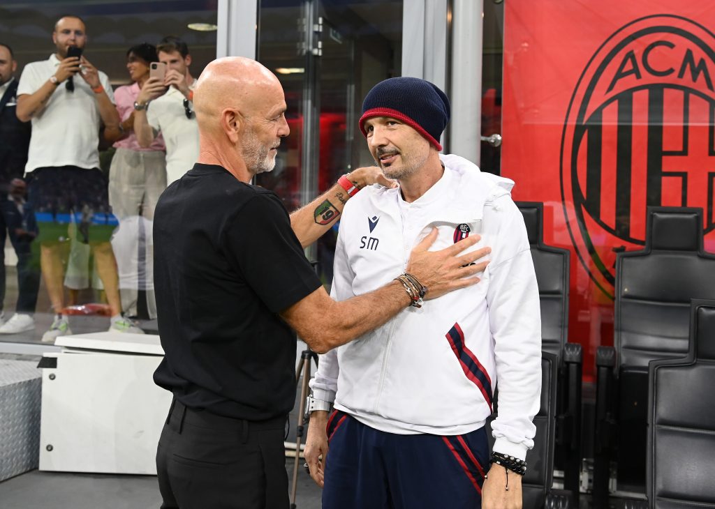 MILAN, ITALY - AUGUST 27: Head coach of AC Milan Stefano Pioli speaks with head coach of Bologna FC Sinisa Mihajlovic before the Serie A match between AC MIlan and Bologna FC at Stadio Giuseppe Meazza on August 27, 2022 in Milan, Italy. (Photo by Claudio Villa/AC Milan via Getty Images)