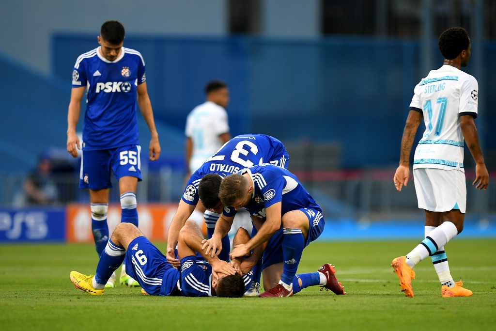 ZAGREB, CROATIA - SEPTEMBER 06: Bruno Petkovic celebrates with Stefan Ristovski and Josip Sutalo after Mislav Orsic of Dinamo Zagreb (not pictured) scored their sides first goal during the UEFA Champions League group E match between Dinamo Zagreb and Chelsea FC at Stadion Maksimir on September 06, 2022 in Zagreb, Croatia. (Photo by Jurij Kodrun/Getty Images)
